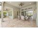 Covered patio features tile flooring, ceiling fans and an outdoor dining area with views of the pool at 16712 Courtyard Loop, Land O Lakes, FL 34638