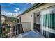 View of condo balcony with railing and sliding glass doors to the updated interior at 1799 N Highland Ave # 106, Clearwater, FL 33755