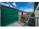 View of a condo balcony with a green screen with view of common area with stairs at 1799 N Highland Ave # 106, Clearwater, FL 33755