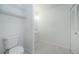 White bathroom with tiled floors and updated fixtures at 1799 N Highland Ave # 106, Clearwater, FL 33755
