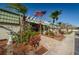 Exterior of the community clubhouse, featuring mature landscaping and a decorative pergola at 1799 N Highland Ave # 106, Clearwater, FL 33755