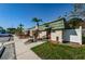 Exterior of the community clubhouse, featuring mature landscaping and easy parking at 1799 N Highland Ave # 106, Clearwater, FL 33755