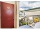 Inviting condo entrance with a front door, stairs, plants, and building exterior, creating a warm welcome at 1799 N Highland Ave # 106, Clearwater, FL 33755