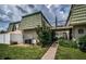 Exterior of condo featuring a green roof, mature landscaping, and a patio at 1799 N Highland Ave # 106, Clearwater, FL 33755