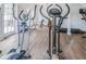 Well-equipped gym features elliptical machines and other exercise equipment on hardwood floors at 1799 N Highland Ave # 106, Clearwater, FL 33755