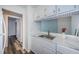 The bright kitchen offers white cabinets, updated hardware, and stainless steel sink at 1799 N Highland Ave # 106, Clearwater, FL 33755