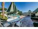 Community pool area with several seating areas surrounded by lush, mature landscaping at 1799 N Highland Ave # 106, Clearwater, FL 33755