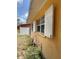 Side view of the home showcasing the window with shutters and exterior paint at 1806 Marvy Ave, Tampa, FL 33612