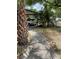 Landscaped front yard featuring a walkway, mature trees, and a carport at 1806 Marvy Ave, Tampa, FL 33612