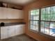 Cozy interior corner featuring white cabinets, granite counters, with a large window with natural light at 1806 Marvy Ave, Tampa, FL 33612