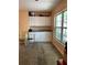 Well-lit area features white cabinets, dark counters, a large window, and resilient flooring at 1806 Marvy Ave, Tampa, FL 33612