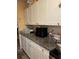 Kitchen with ample cabinet space, dark countertops, and essential appliances for home cooking at 1806 Marvy Ave, Tampa, FL 33612