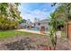 Private backyard with a swimming pool, patio, and lush greenery providing a serene outdoor oasis at 2620 49Th N Ave, St Petersburg, FL 33714