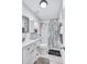 Well-lit bathroom featuring a shower with stylish shower curtain and white vanity at 2620 49Th N Ave, St Petersburg, FL 33714