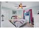 Bright bedroom with a ceiling fan, window with curtains, and a comfortable bed at 2620 49Th N Ave, St Petersburg, FL 33714