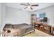Bedroom features ceiling fan, bed, wall mounted TV, and wall display shelves at 2620 49Th N Ave, St Petersburg, FL 33714