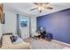 Spare bedroom with a ceiling fan, large window, and a home office setup at 2620 49Th N Ave, St Petersburg, FL 33714