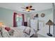 Cozy bedroom featuring a ceiling fan, TV, and window with stylish curtains at 2620 49Th N Ave, St Petersburg, FL 33714