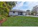 Inviting single-Gathering home featuring manicured lawn, lush landscaping, and a screened-in porch area at 2620 49Th N Ave, St Petersburg, FL 33714