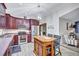 Stylish kitchen featuring wood cabinetry, stainless steel appliances, breakfast bar island, and open layout at 2620 49Th N Ave, St Petersburg, FL 33714