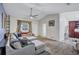 Open-concept living space with large sectional couch, plush carpet, and ample natural light at 2620 49Th N Ave, St Petersburg, FL 33714