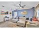 Spacious living room with high ceilings, ceiling fan, large sectional sofa, and neutral carpet flooring at 2620 49Th N Ave, St Petersburg, FL 33714