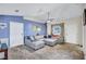 Comfortable living room featuring a large sectional sofa, neutral carpeting, and blue accent wall at 2620 49Th N Ave, St Petersburg, FL 33714