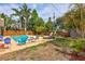 Inviting backyard pool area with comfortable seating, surrounded by lush landscaping and a privacy fence at 2620 49Th N Ave, St Petersburg, FL 33714