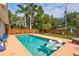 Resort-style pool area featuring lush tropical landscaping, perfect for relaxation and entertainment at 2620 49Th N Ave, St Petersburg, FL 33714