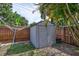 A backyard shed, offering extra storage space, sits neatly along the wooden fence, blending into the landscape at 2620 49Th N Ave, St Petersburg, FL 33714