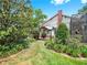 Serene backyard featuring a landscaped garden, patio, and partial view of home at 2621 Stearns Rd, Valrico, FL 33596