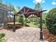 Outdoor entertaining area featuring a stone patio and a shaded gazebo at 2621 Stearns Rd, Valrico, FL 33596