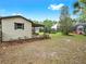 Spacious backyard with a shed and covered seating area, offering a serene and private outdoor space at 2621 Stearns Rd, Valrico, FL 33596