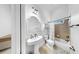 Bathroom featuring a white sink and toilet and a shower behind a curtain at 2621 Stearns Rd, Valrico, FL 33596