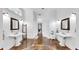 Bathroom featuring brown tile floors, a hallway, and and sinks at 2621 Stearns Rd, Valrico, FL 33596