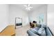 Bedroom features a ceiling fan, large mirror, a desk, a blue couch and neutral carpet at 2621 Stearns Rd, Valrico, FL 33596