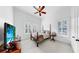 Bedroom featuring neutral carpet, a ceiling fan, a four post bed and shuttered windows at 2621 Stearns Rd, Valrico, FL 33596