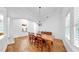 Elegant dining room with hardwood floors, large wooden table, and natural light at 2621 Stearns Rd, Valrico, FL 33596