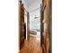 View of bedroom through rustic sliding doors with wood floors and a light-colored floral rug at 2621 Stearns Rd, Valrico, FL 33596