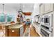 Gourmet kitchen featuring stainless steel appliances, granite countertops, and a pot rack over the island at 2621 Stearns Rd, Valrico, FL 33596