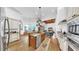 Spacious kitchen with granite countertops and stainless steel appliances flowing into an open living room at 2621 Stearns Rd, Valrico, FL 33596