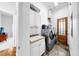 Well-equipped laundry room with sink, storage, and modern washer and dryer units at 2621 Stearns Rd, Valrico, FL 33596
