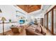 Spacious living room featuring hardwood floors, a fireplace, built-in shelving and a wooden ceiling at 2621 Stearns Rd, Valrico, FL 33596