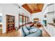 Inviting living room with hardwood floors, a wooden ceiling, fireplace, and access to the pool area at 2621 Stearns Rd, Valrico, FL 33596