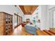 Bright living room with hardwood floors, a wooden ceiling, fireplace, and access to the pool area at 2621 Stearns Rd, Valrico, FL 33596