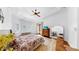 Bright main bedroom featuring hardwood floors, ceiling fan, and exterior access to the balcony at 2621 Stearns Rd, Valrico, FL 33596