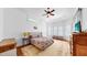 Bright main bedroom with tray ceiling, hardwood floors, and multiple windows at 2621 Stearns Rd, Valrico, FL 33596