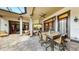 Expansive outdoor patio with a stone floor, comfortable seating, ceiling fans, and elegant architectural details at 2621 Stearns Rd, Valrico, FL 33596