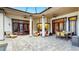 Luxury outdoor patio featuring stone floors, ceiling fans, refined furniture, and stunning architectural elements at 2621 Stearns Rd, Valrico, FL 33596