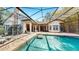 Beautiful screened-in pool with stone patio, ideal for relaxation and entertaining in a private outdoor setting at 2621 Stearns Rd, Valrico, FL 33596